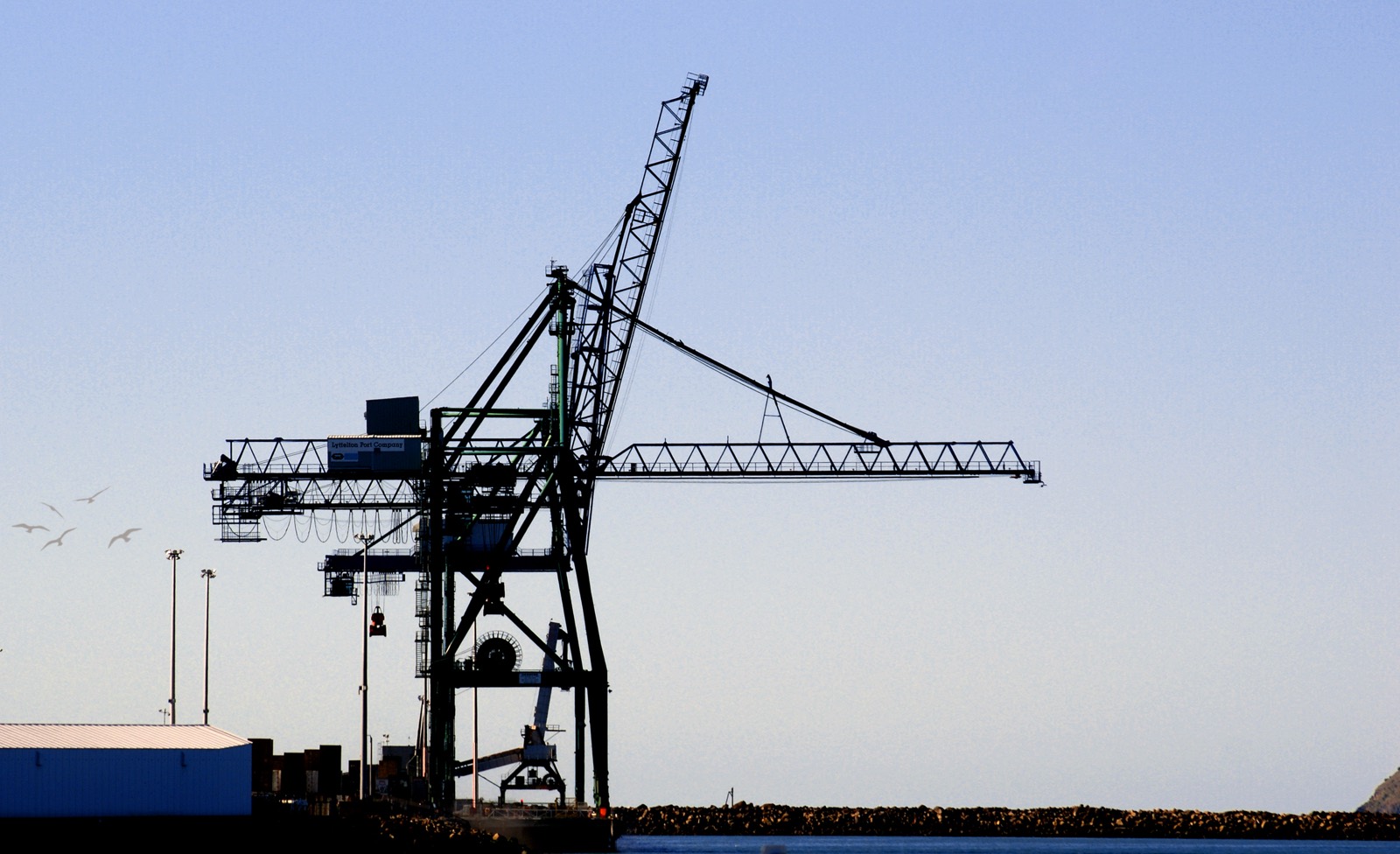A container crane lifting a container at a port terminal